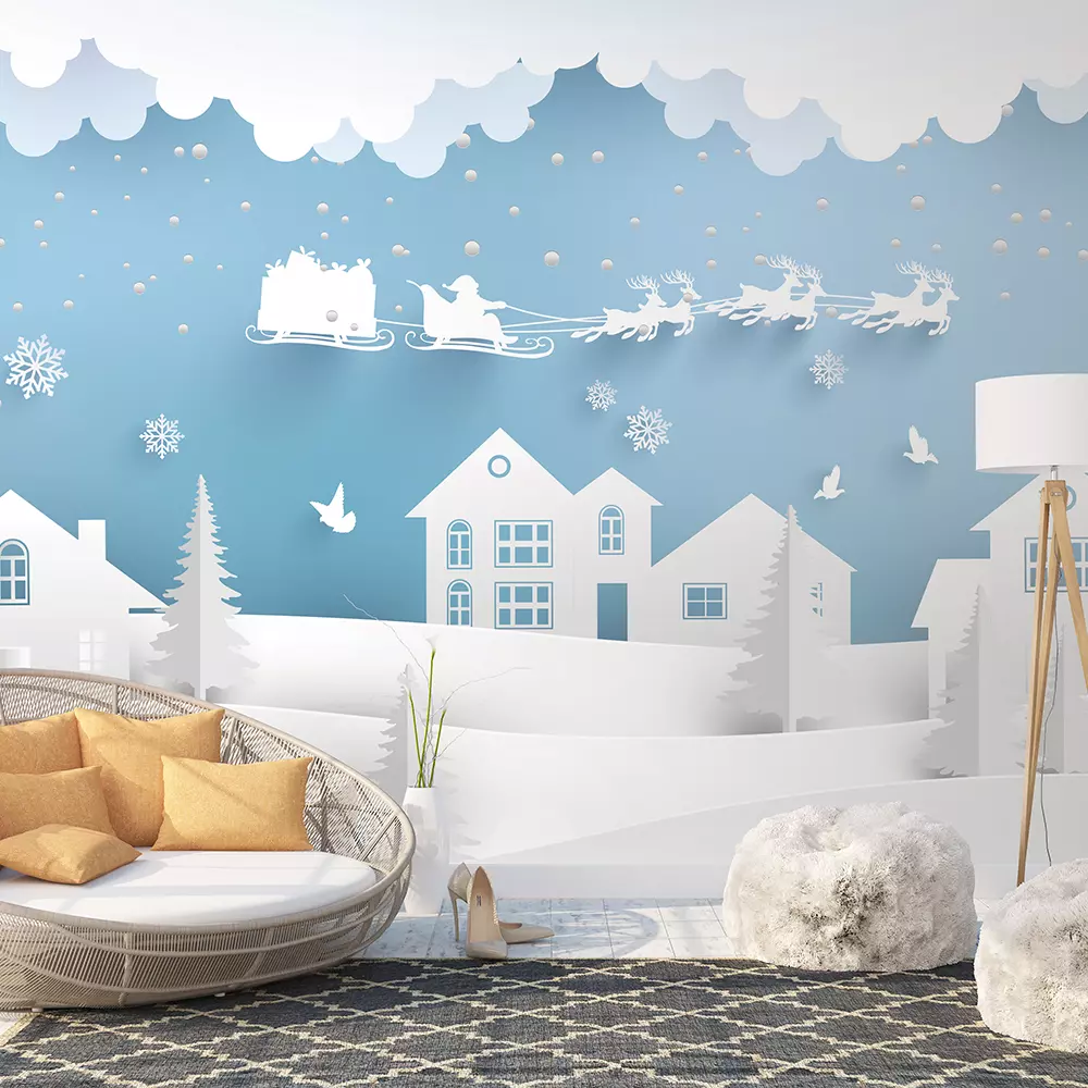 santa claus with deer flying over a small town on a snowy hill